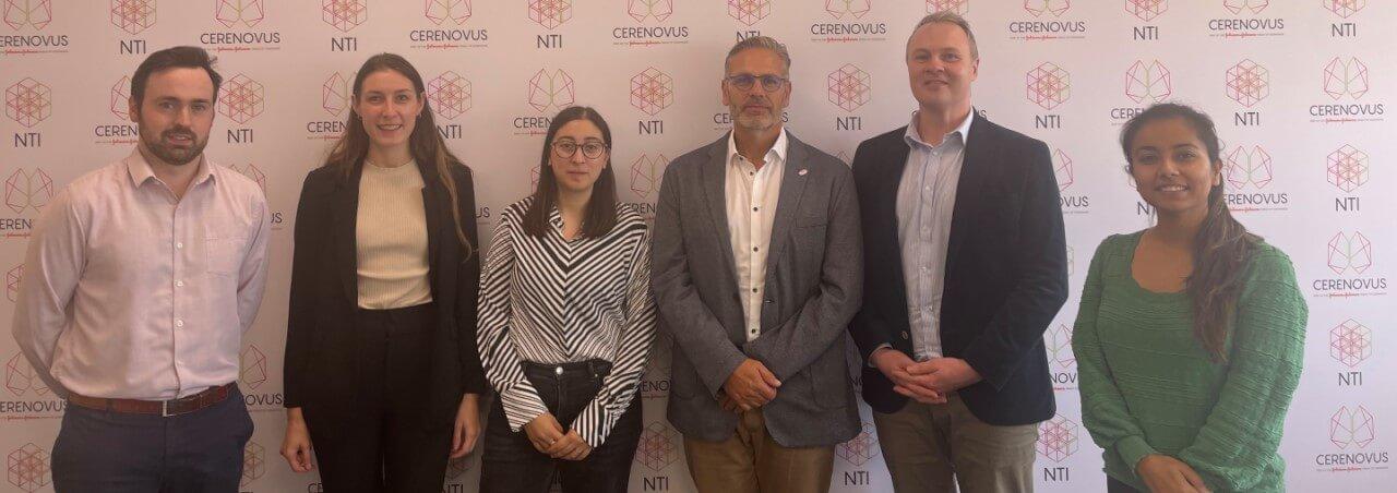 Patrick Brouwer, in the center of 5 colleagues in front of a CERENOVUS NTI branded background